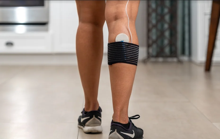 FlexPulse device being used on the back of a calf muscle