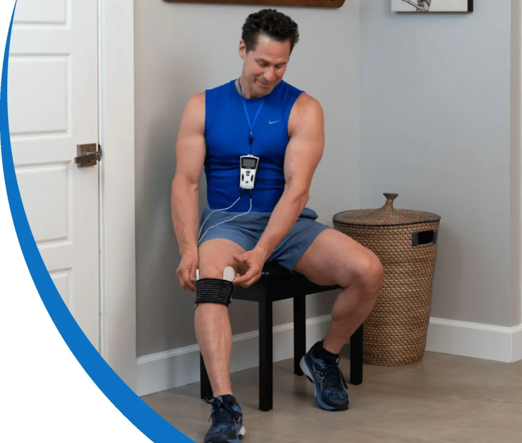 Athletic man utilizing his PEMF device around his knee - picture 1