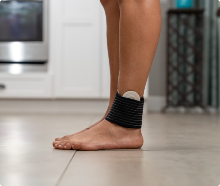 Coil pad strapped around an ankle