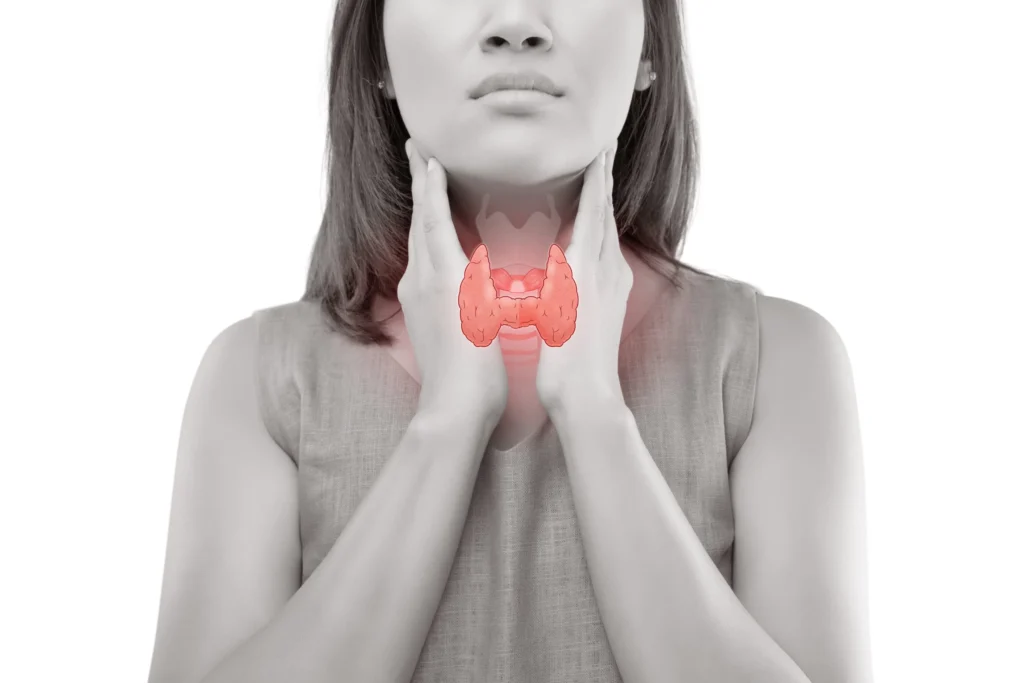 Woman rubbing her neck as though her thyroids are in pain